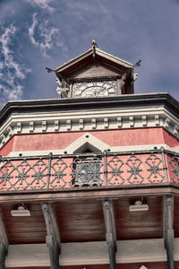 Low angle view of old building against cloudy sky