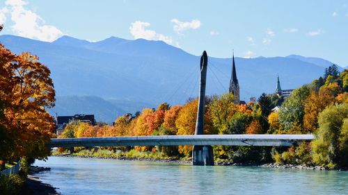 Scenic view of river amidst trees against sky during autumn