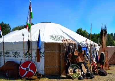 View of nomadic-type tent on steppe against clear blue sky