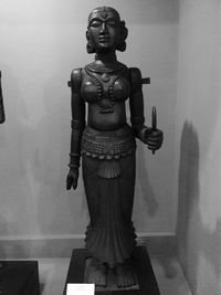 Statue of buddha against wall