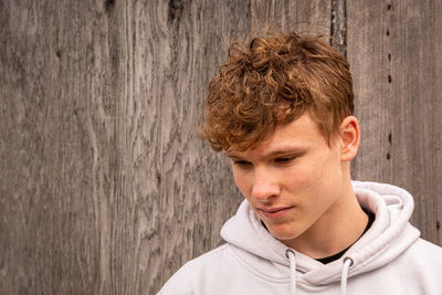 Close-up portrait of young man against wall