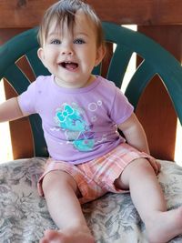 Portrait of cute baby girl sitting at home