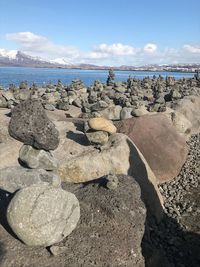 Rocks on beach against sky