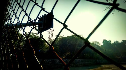 Low angle view of fence against sky