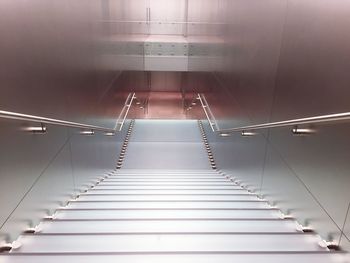 High angle view of narrow stairs along walls