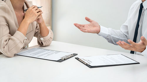 Midsection of doctor examining patient in office