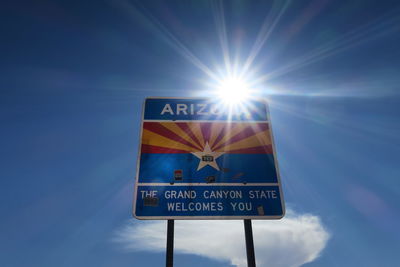 Information sign against blue sky