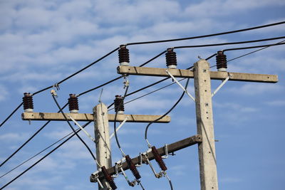 Low angle view of electricity pylon against sky