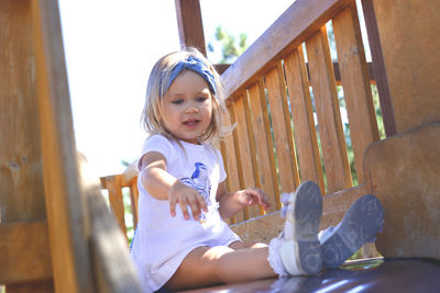 Portrait of cute girl sitting outdoors