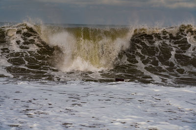 Scenic view of sea waves splashing on shore