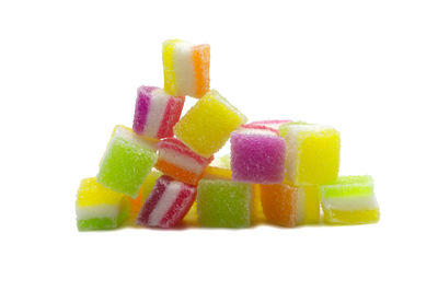 Close-up of multi colored candies against white background