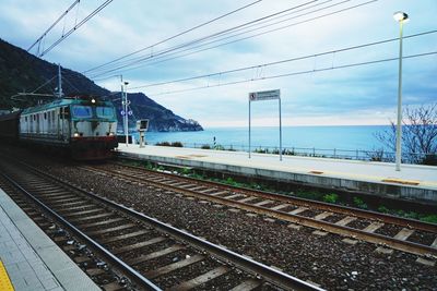 Train on railroad tracks against sky