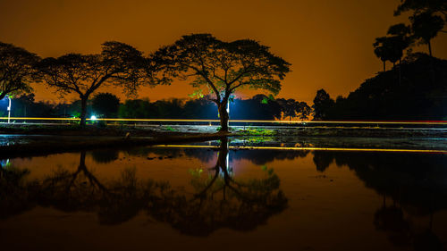 Scenic view of lake against orange sky