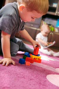 Boy playing with toy at home