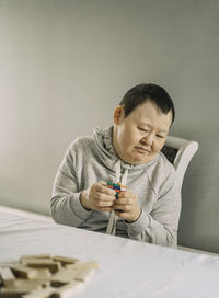 Focused learning, elderly woman with down syndrome engaged in educational board games