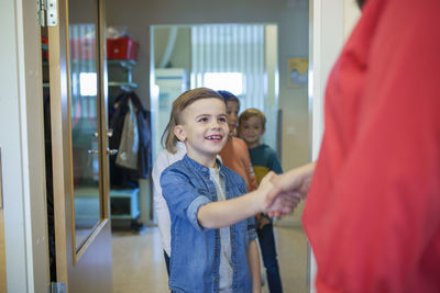 Boy shaking teachers hand