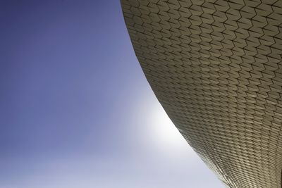 Low angle view of modern building against clear blue sky