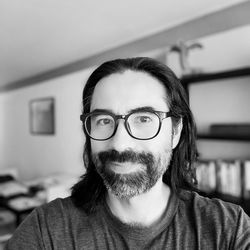 Portrait of young man wearing eyeglasses at home