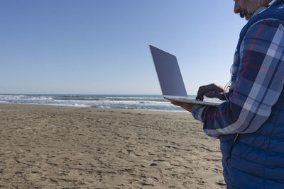 Professional man working on a laptop on the beach person