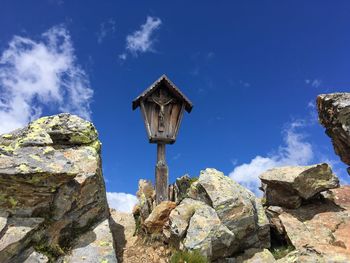 Low angle view of rocks against blue sky