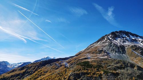 Low angle view of vapor trail in blue sky