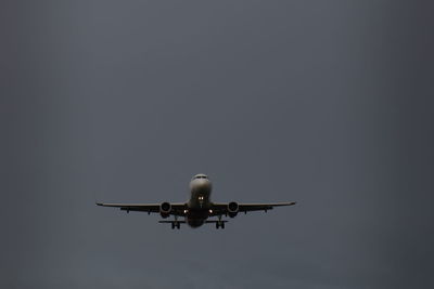 Low angle view of airplane against clear sky