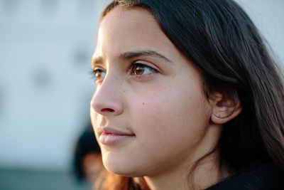 Close up profile of a twelve year old girl in half lit by the sun