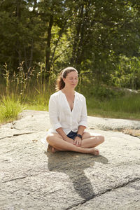 Woman meditating outdoor barefoot