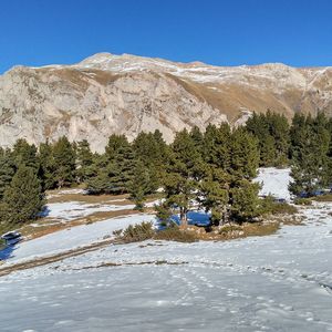 Scenic view of mountains against clear blue sky