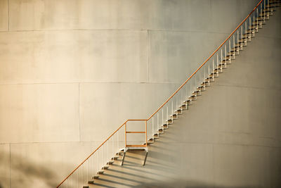 Low angle view of staircase against storage tank