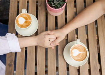 Cropped hands of person preparing food on table