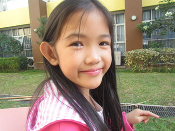 Portrait of smiling girl in yard