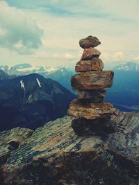 Scenic view of mountains against cloudy sky