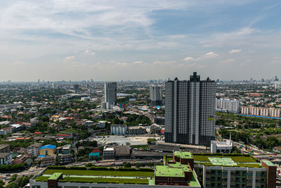 High angle view of buildings in city against sky