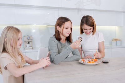 Portrait of smiling friends having food at home