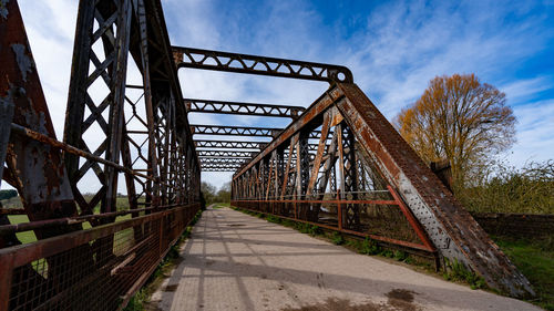 Shot looking down the bridal way of an old rusty iron/steel railway bridge