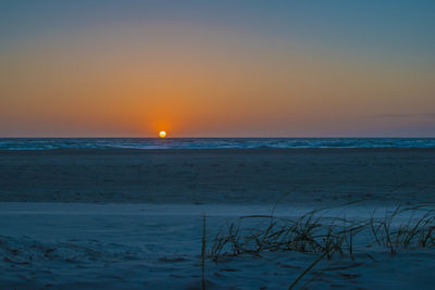 Scenic view of sea against sky at sunset