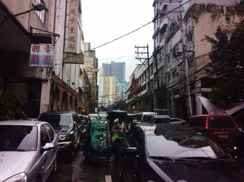 Cars on street amidst buildings in city