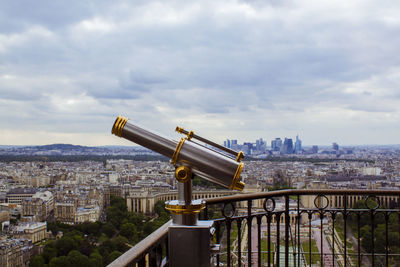 View of cityscape against cloudy sky