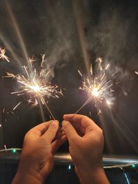 Low angle view of firework display at night