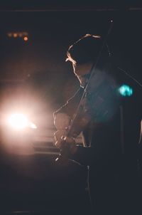 Close-up of illuminated lighting against sky at night