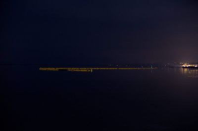 Scenic view of sea against clear sky at night