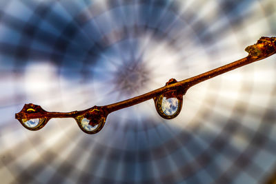 Low angle view of chain against sky