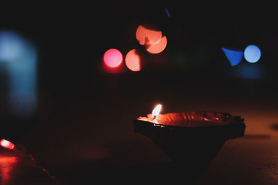 Close-up of lit candle in the dark