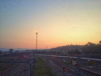 Railroad tracks against sky during sunset