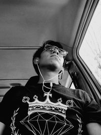 Man looking down while sitting in car