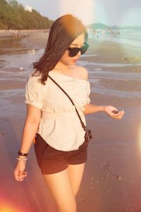 Young woman standing at beach