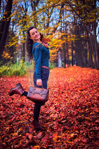 Full length of woman in park during autumn