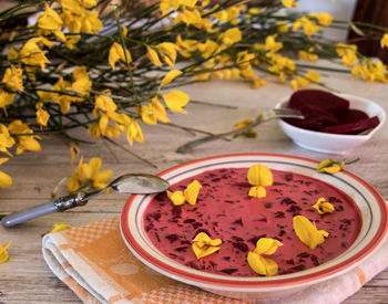 Close-up of yellow flower in bowl on table