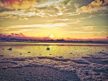 Scenic view of beach against sky during sunset